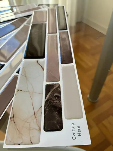 Muestrario de guardas autoadhesivas de mosaico 3D con diferentes diseños en blanco, grises y negro